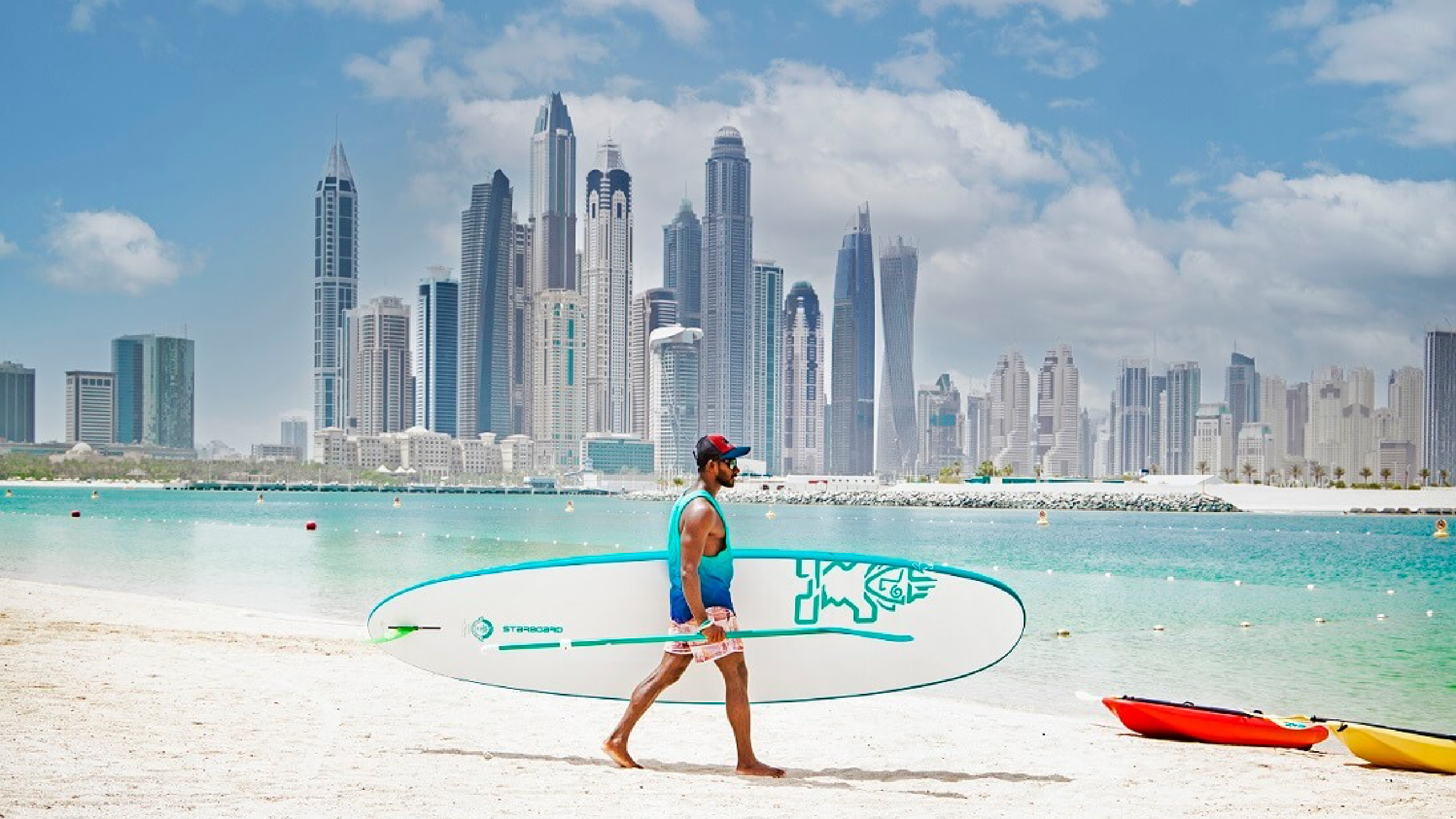 A Man holding surfboard on the Beach