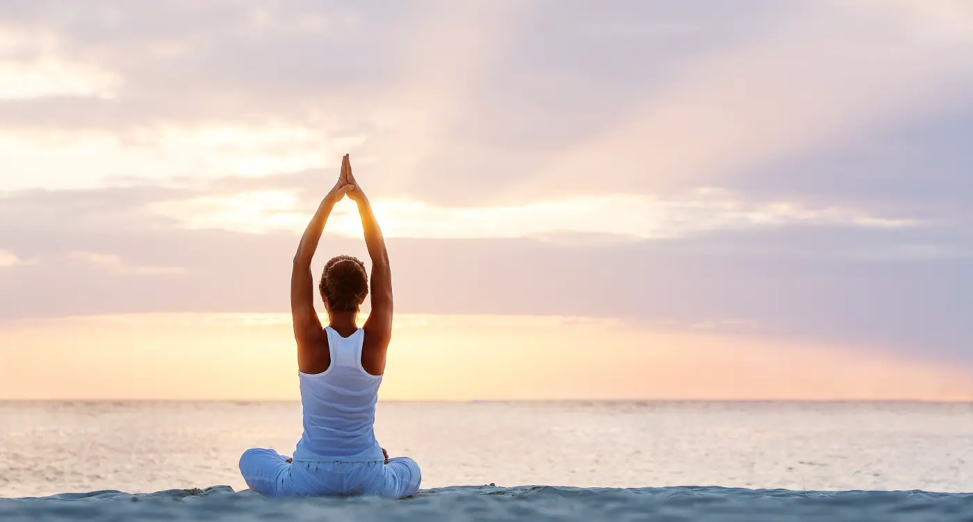 Woman on the Beach Doing Yoga