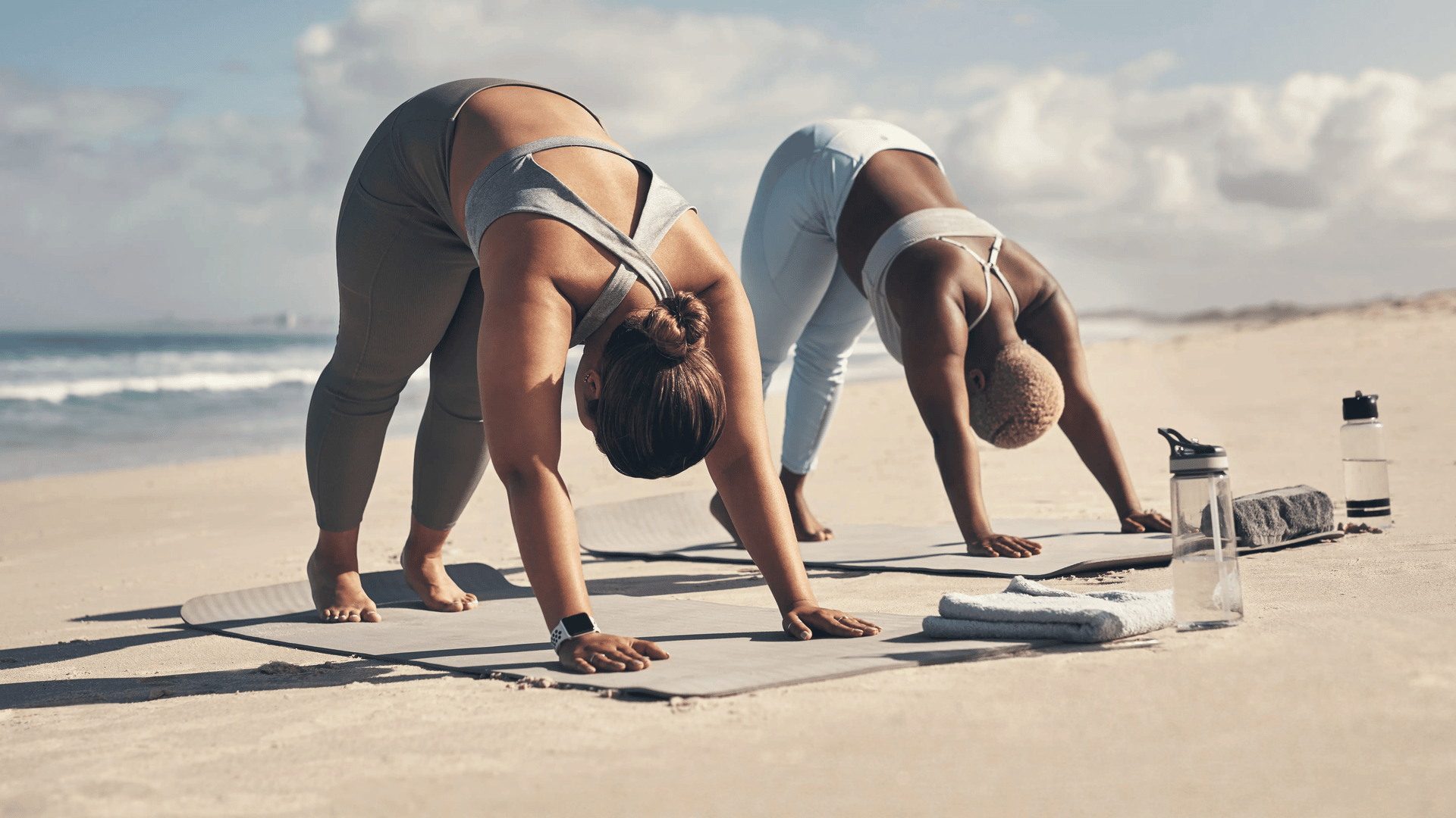 Two Women on the Beach Doing Yoga