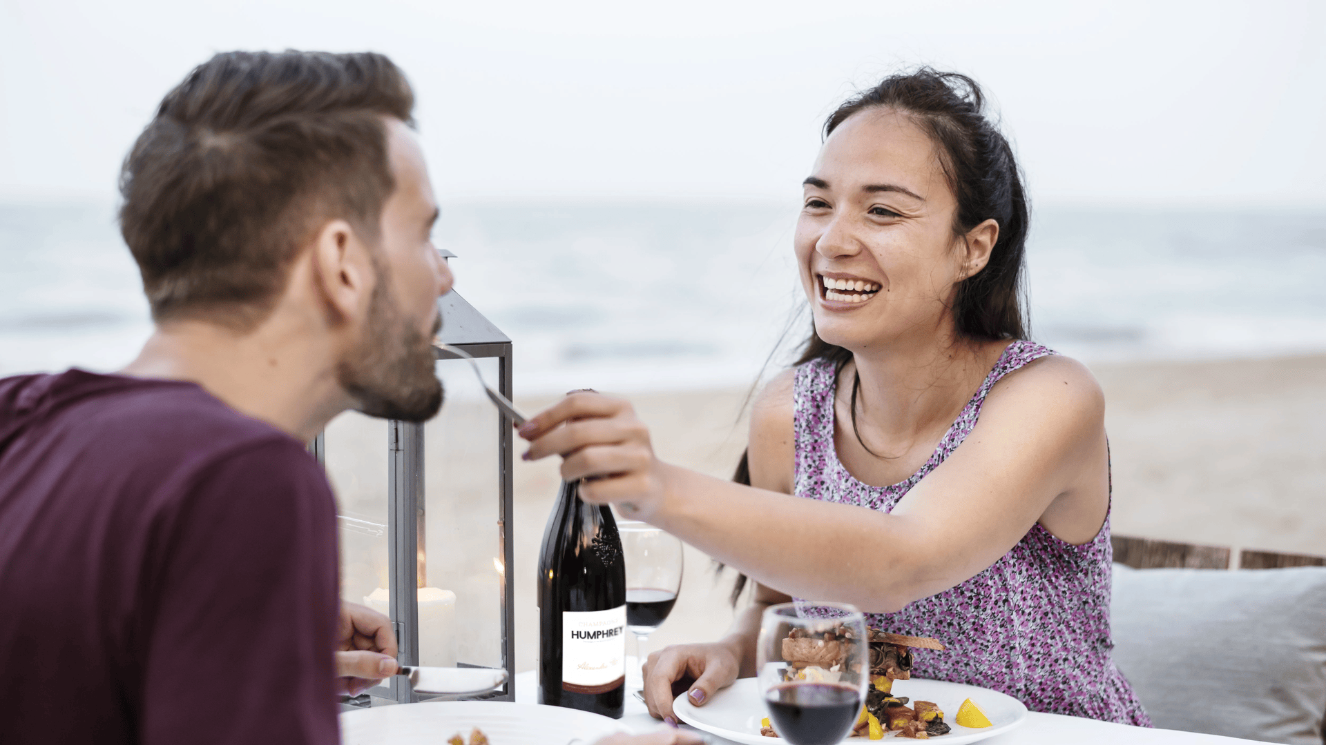 Couple Enjoying a Romantic Dinner at the Beach