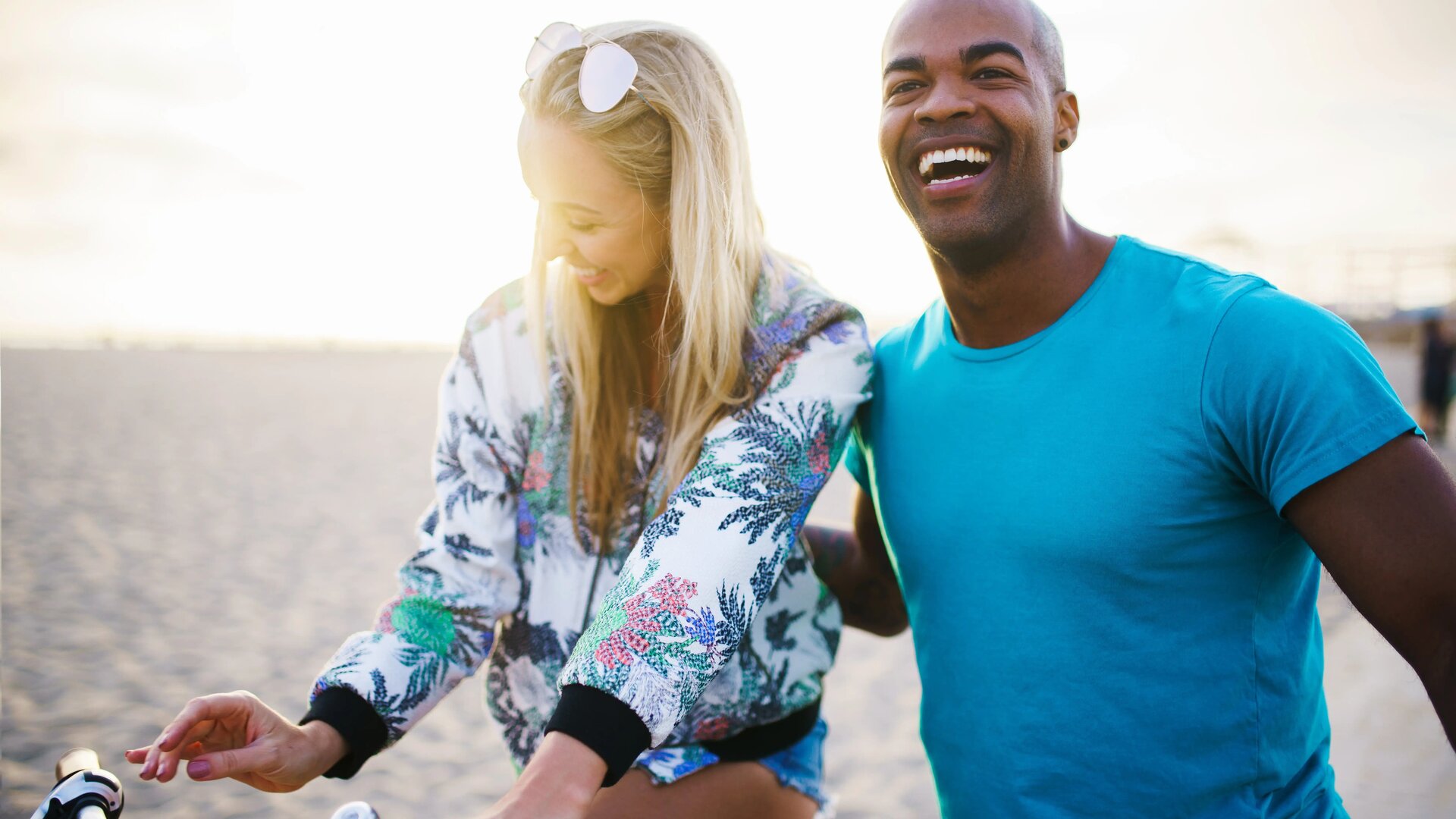 Couple Doing Bike Cycling on the Beach