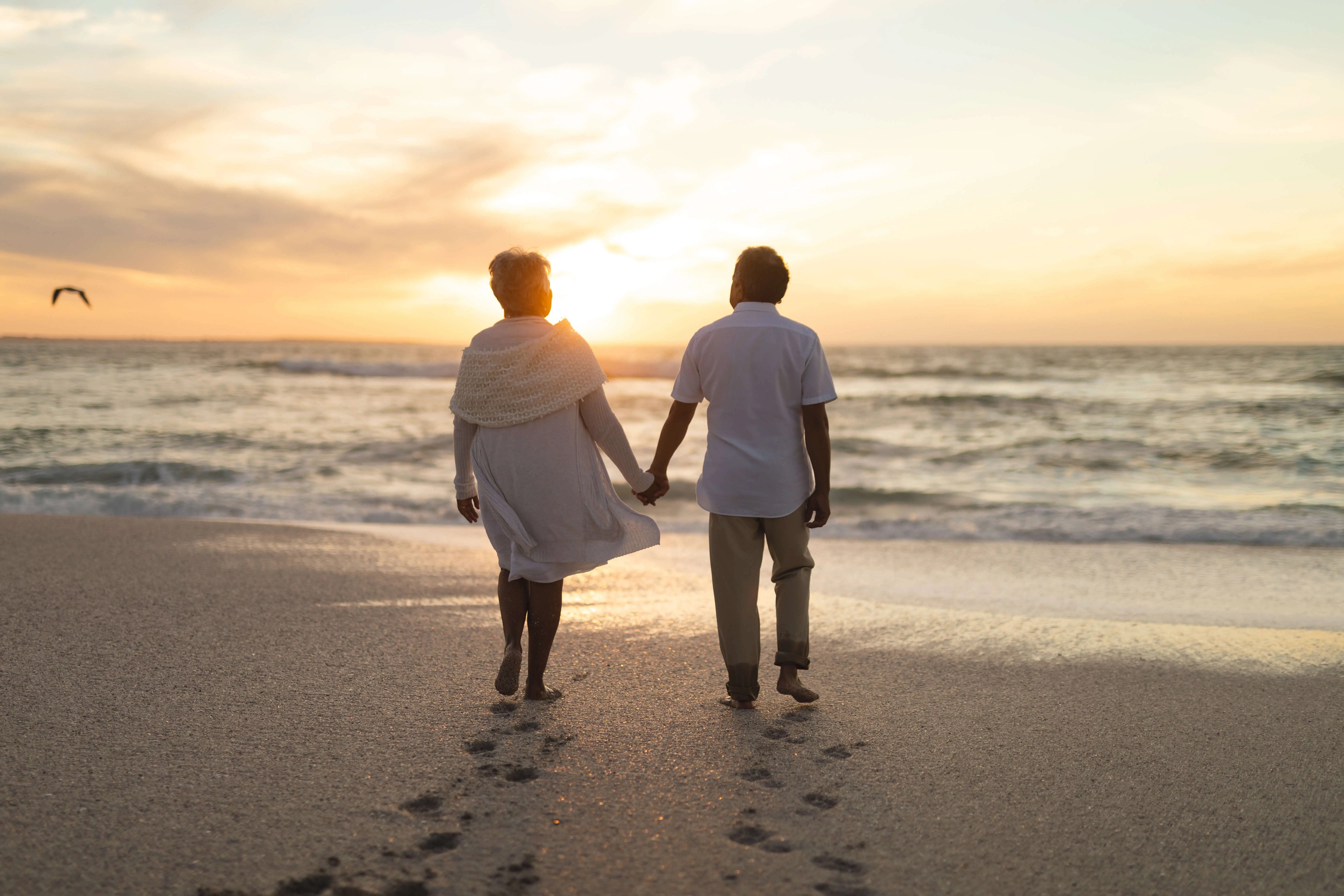 Old Couple walking on the Beach